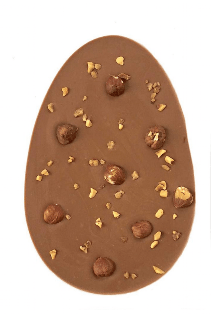 Go Nuts Easter Egg. Egg-shaped milk chocolate easter egg bar topped with whole and chopped, caramelised hazelnuts