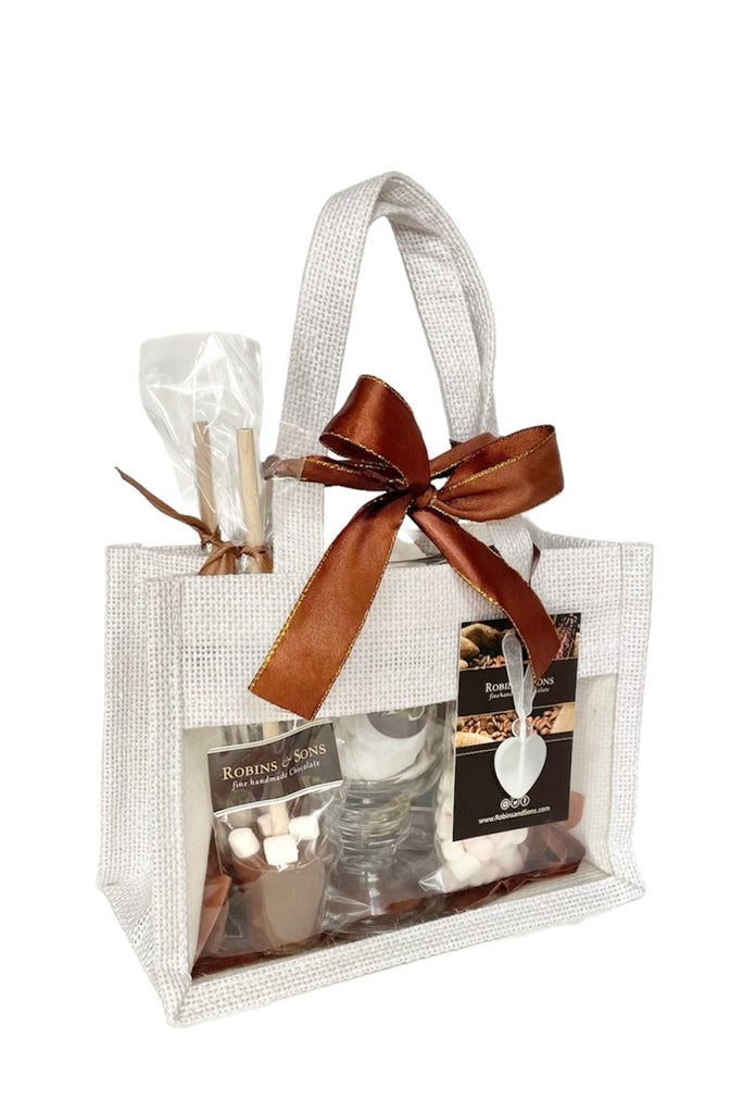 Hot chocolate set with mug inside a white jute bag tied with ribbon