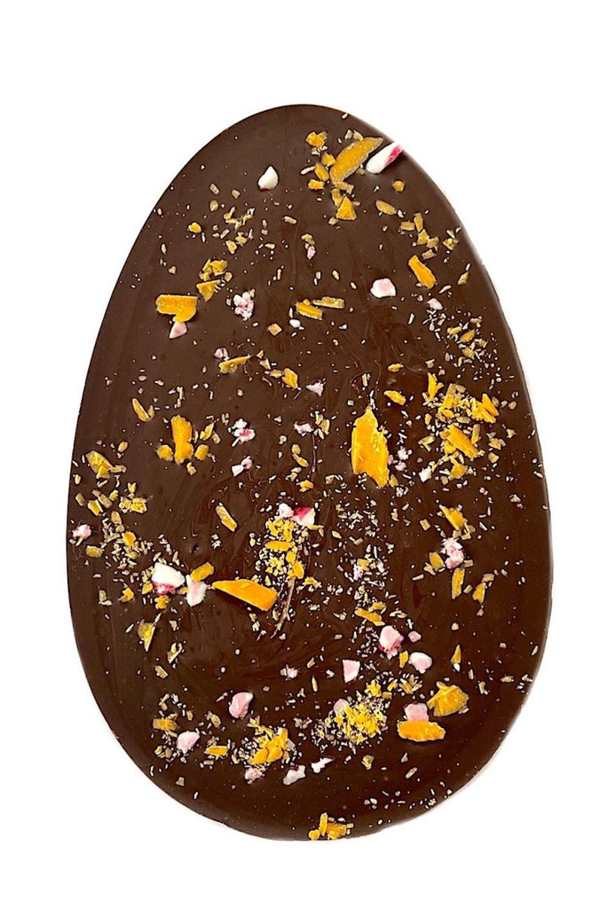 Dark chocolate orange easter egg bar with orange oil and topped with fruit candy cane and orange chocolate shavings