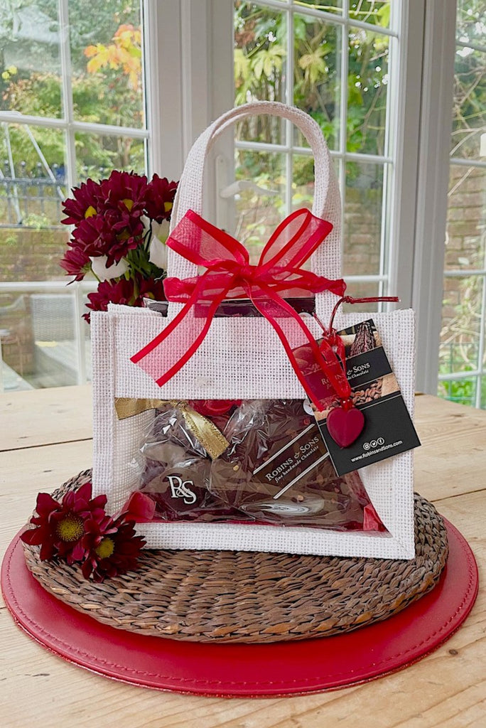 Ruby gift bag containing assorted dark chocolate treats