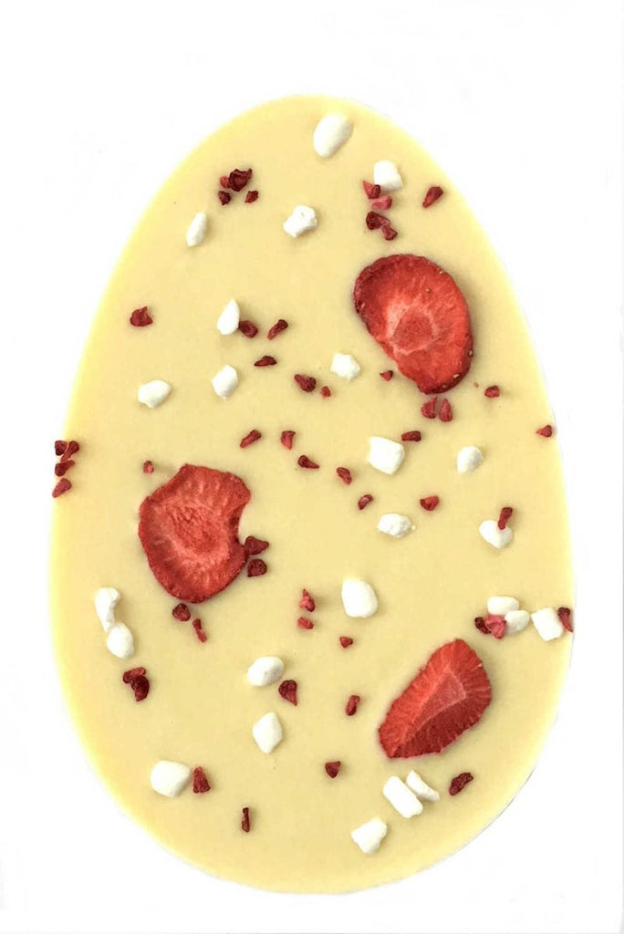 Very Berry Easter Egg. Oval shaped white chocolate bar topped with strawberry slices, meringue and raspberry pieces.