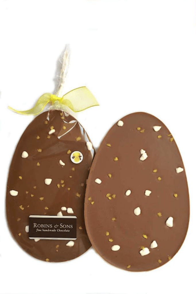 Sicilian Lemon Crunch Easter Egg. Oval egg-shaped milk chocolate bar with lemon crystals and meringue pieces.