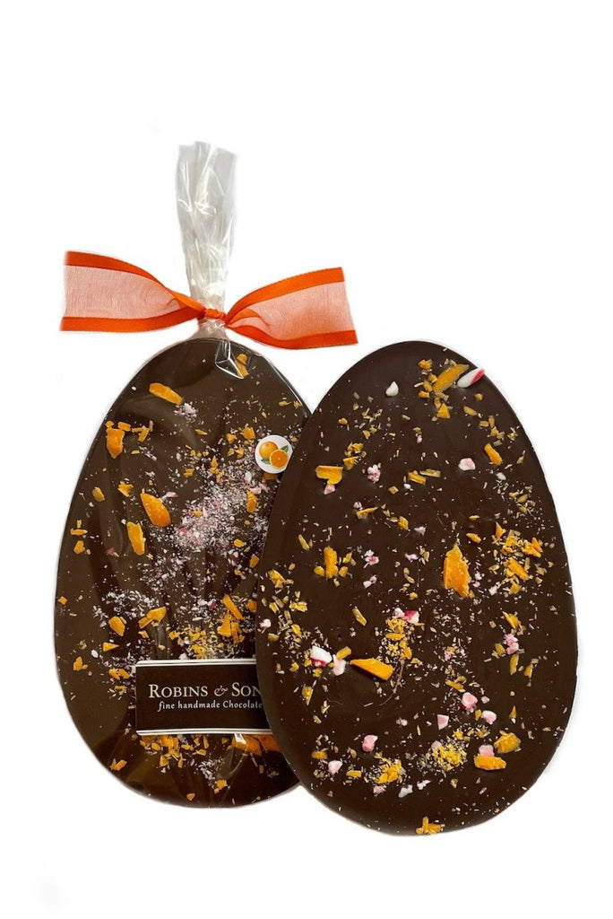 dark orange chocolate easter egg bar packed in clear packaging topped with an orange ribbon bow