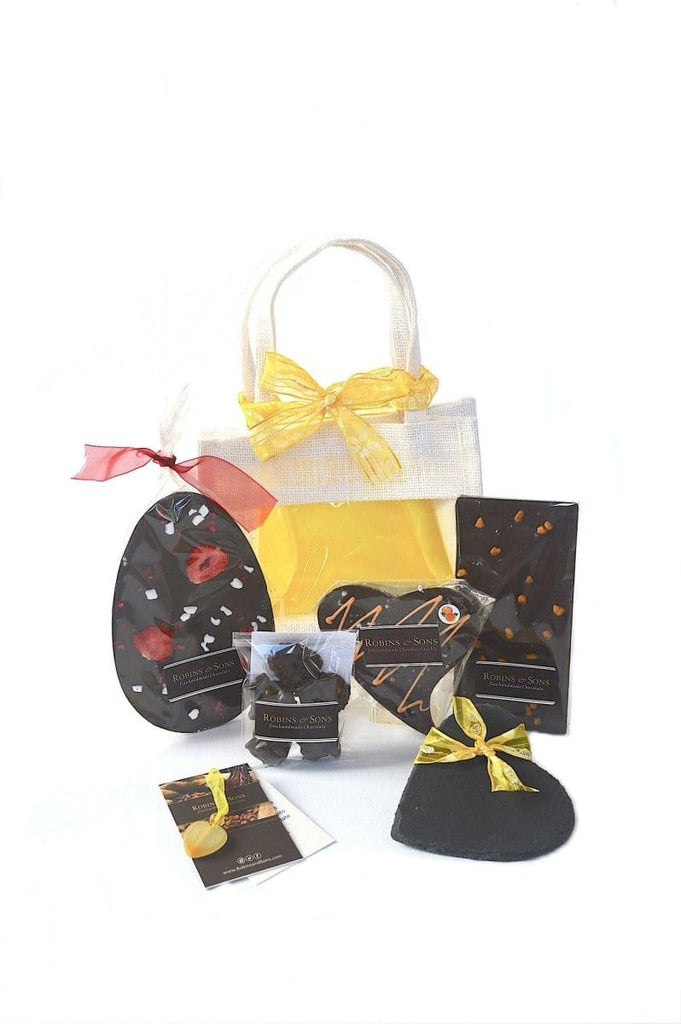 Easter dark chocolate gift bag. contains dark chocolate easter egg topped with strawberries, nut clusters, orange heart bar, dark chocolate chilli bar, slate heart coaster