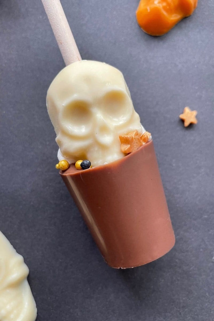 Milk chocolate hot chocolate stirrer topped with white chocolate skull