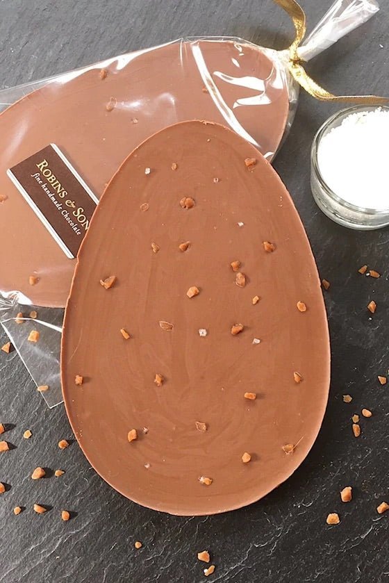 Salted caramel Nibble Easter Egg. Egg-shaped milk chocolate bar topped with salted caramel pieces and mediterranean sea salt flakes