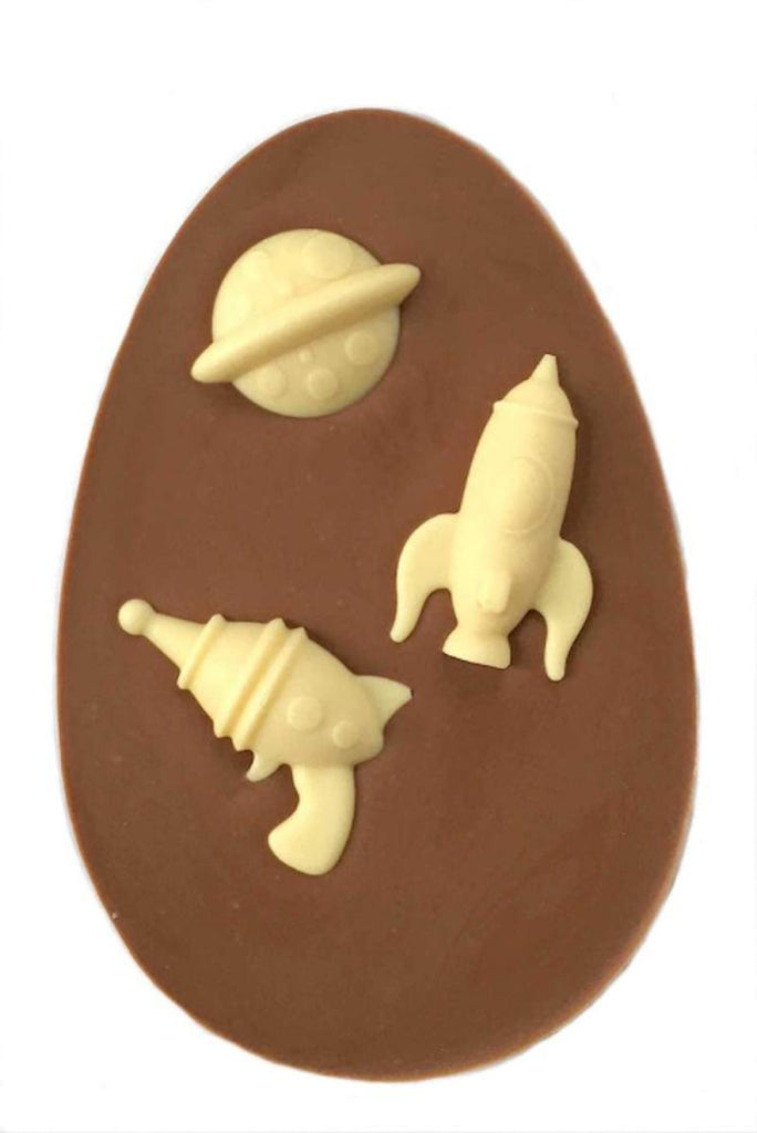 Space explorer easter egg. Egg shaped milk chocolate bar topped with 3 assorted white chocolate space shapes